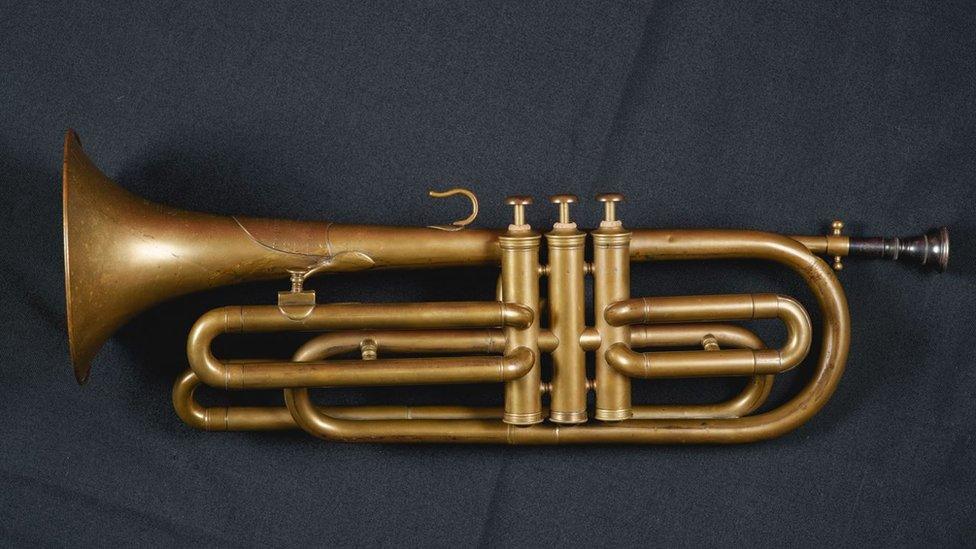 A trumpet on a black cloth