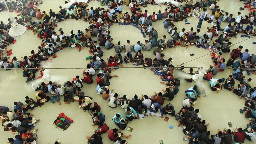 Muslim students in Indonesia read copies of the holy book "Koran" on the first day of the holy month of Ramadan