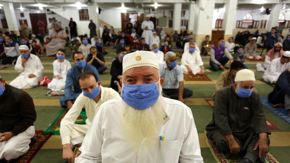 Muslims, wearing masks and maintaining the social distancing, gather to perform Eid al-Fitr prayer in Gaza