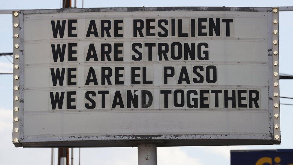 A sign is posted near the scene of the mass shooting at El Paso, which reads: "We are resilient, we are strong, we are El Paso, we stand together."