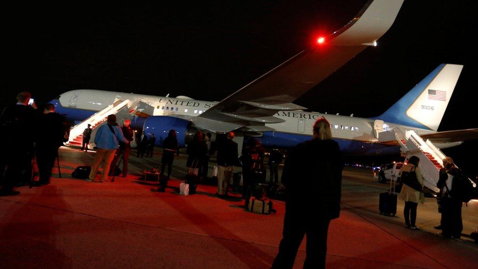 White House staff, Secret Service agents and journalists wait on the tarmac for U.S. President Donald Trump to deplane as he returns from a weekend at his New Jersey golf estate home via Air Force One at Joint Base Andrews, Maryland, U.S. May 7, 2017