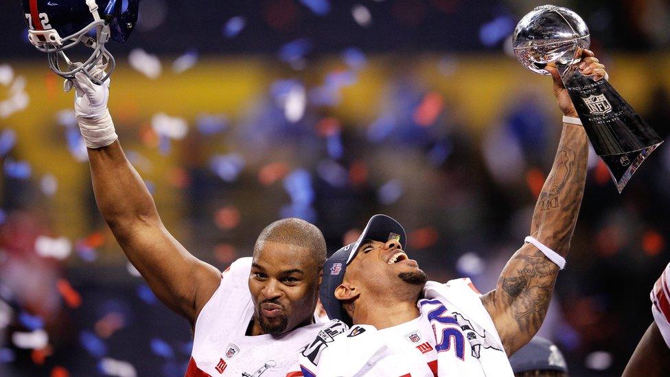 Osi Umenyiora (left) and Devin Thomas (right) of the New York Giants celebrate winning the 2012 Super Bowl.