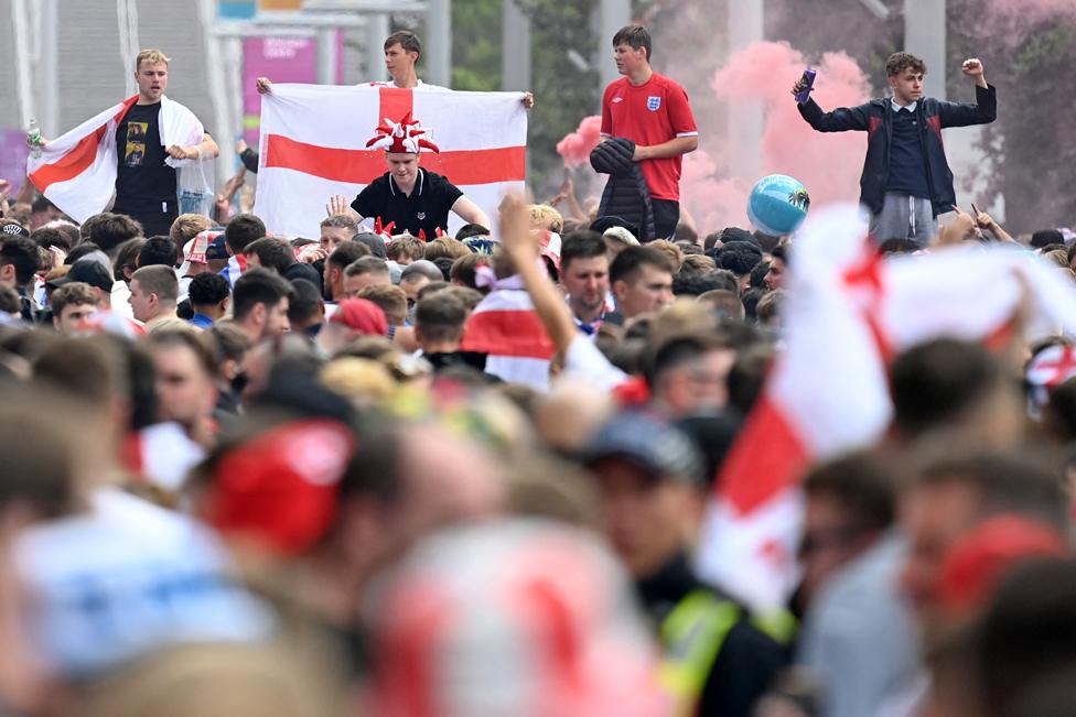 Supporters arrive at Wembley Stadium ahead of the UEFA EURO 2020 final football match between England and Italy in northwest London on July 11, 2021.