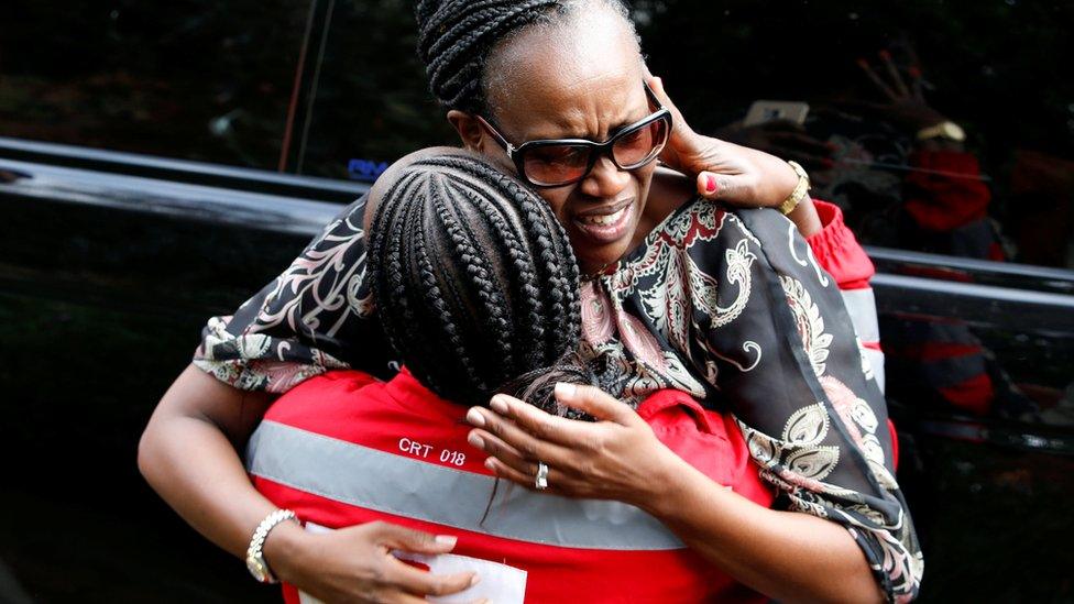 Emergency worker and woman outside Nairobi hotel