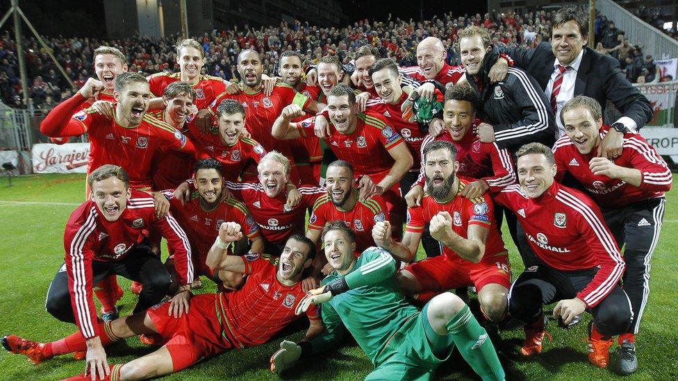 The team pose together for a photograph on the pitch after the match