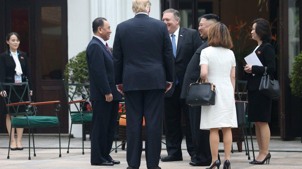 North Korea's leader Kim Jong-un, US President Donald Trump, Kim Yong Chol, Vice Chairman of the North Korean Workers' Party Committee, and US Secretary of State Mike Pompeo talk while Kim Yo-jong looks on from a distance