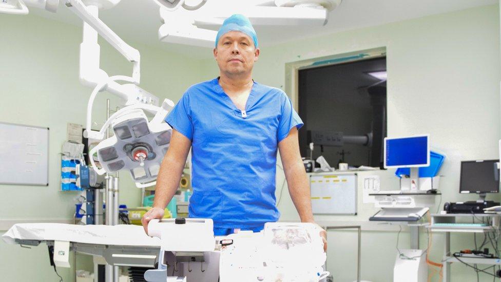 Phil Curry standing in front of the operating table