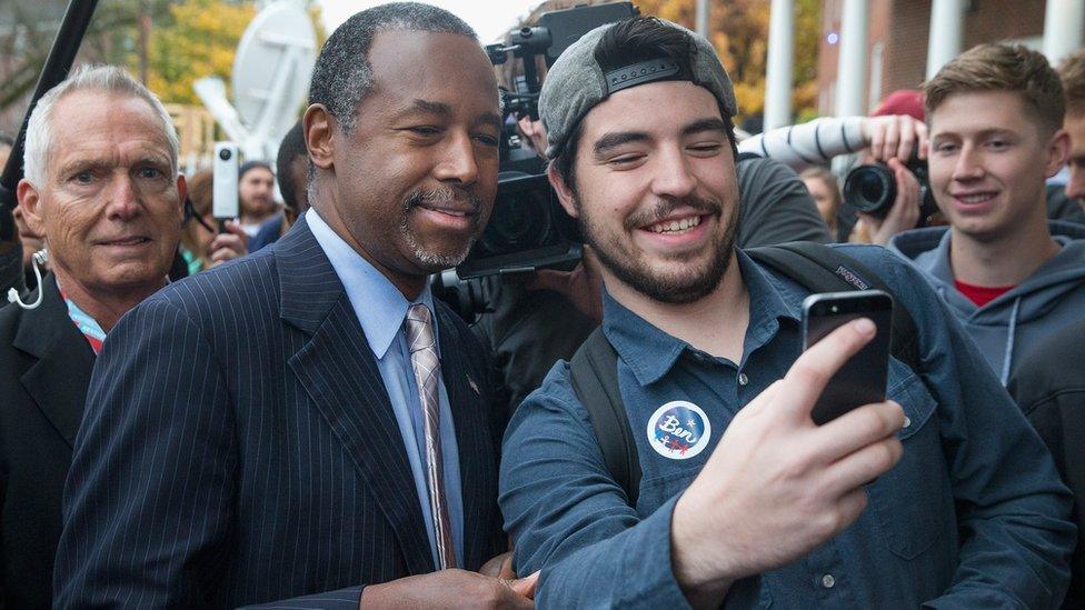 Ben Carson poses for a selfie with a supporter.