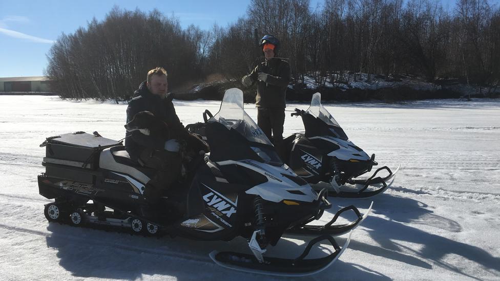 Ludde Noren (left) and Per-Arne Ahlen, raccoon dog hunters, on snow tractors in northern Sweden