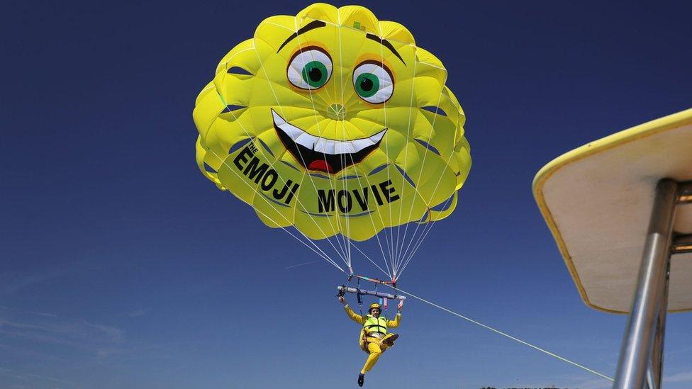 TJ Miller parasails to The Emoji Movie photo call at the start of the Cannes Film Festival