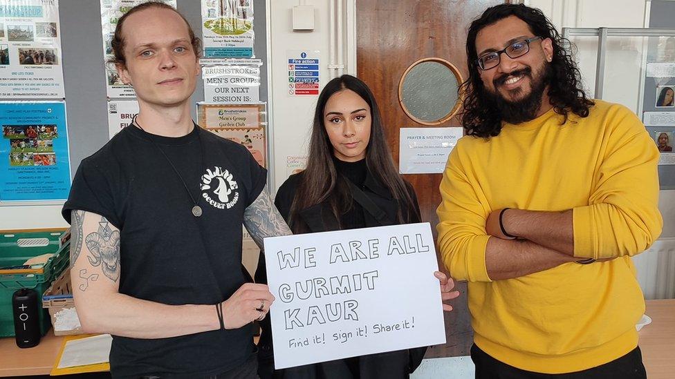 Community members holding a sign