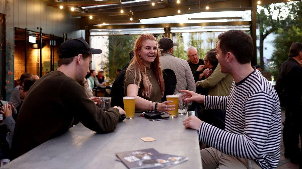 Clients enjoy drinks and table service at a bar in Auckland