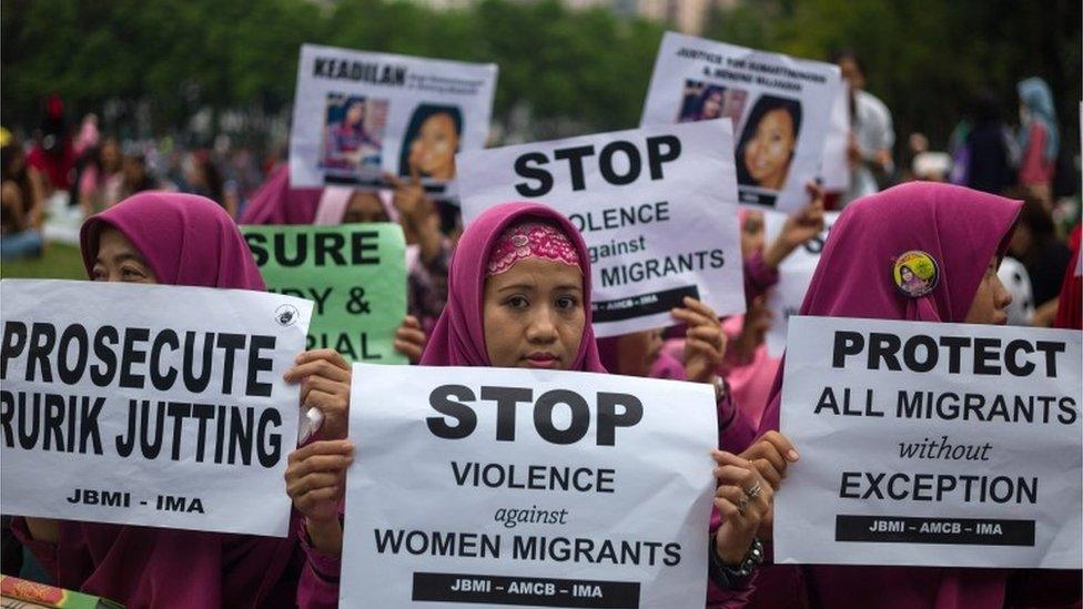 Indonesia migrant workers holds signs during a vigil for fellow Indonesians Sumarti Ningsih and Seneng Mujiasih, aka Jesse Lorena Ruriin, during a vigil at the Victoria Park, Hong Kong, China, 23 October 2016