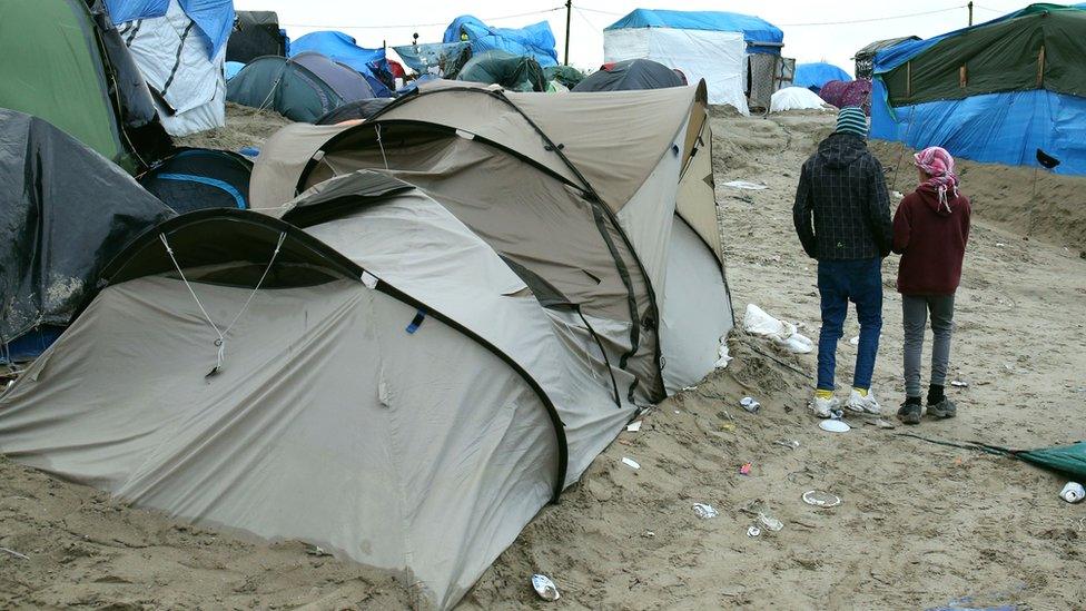 Children next to a tent