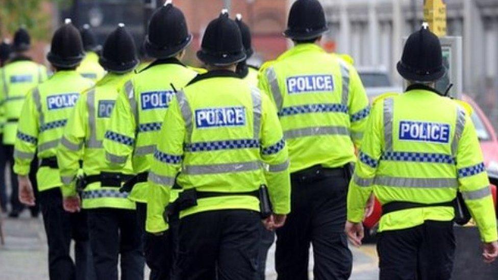 Police officers in high-visibility coats