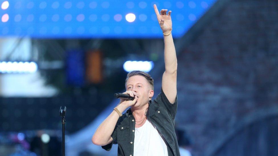 Rapper Macklemore performing on stage