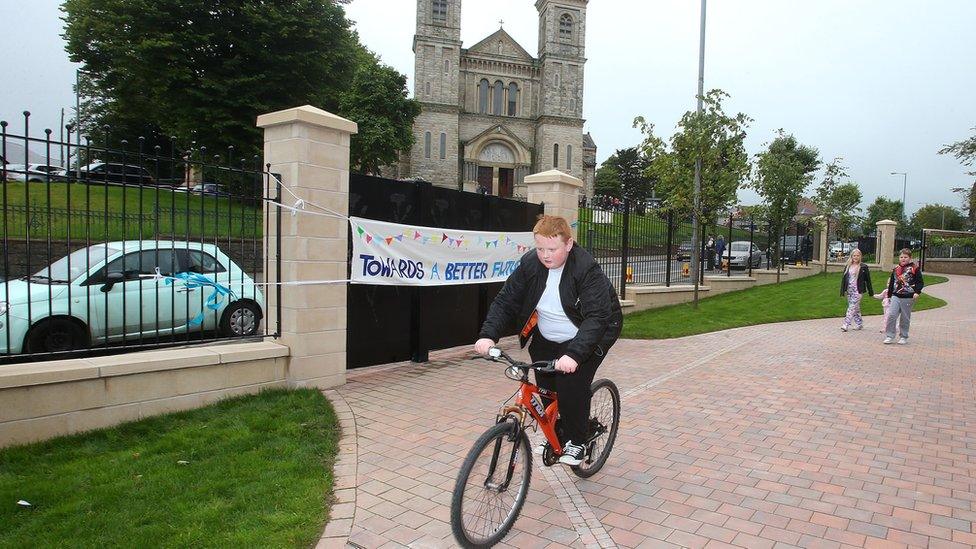 Boy cycles along new landscaped path