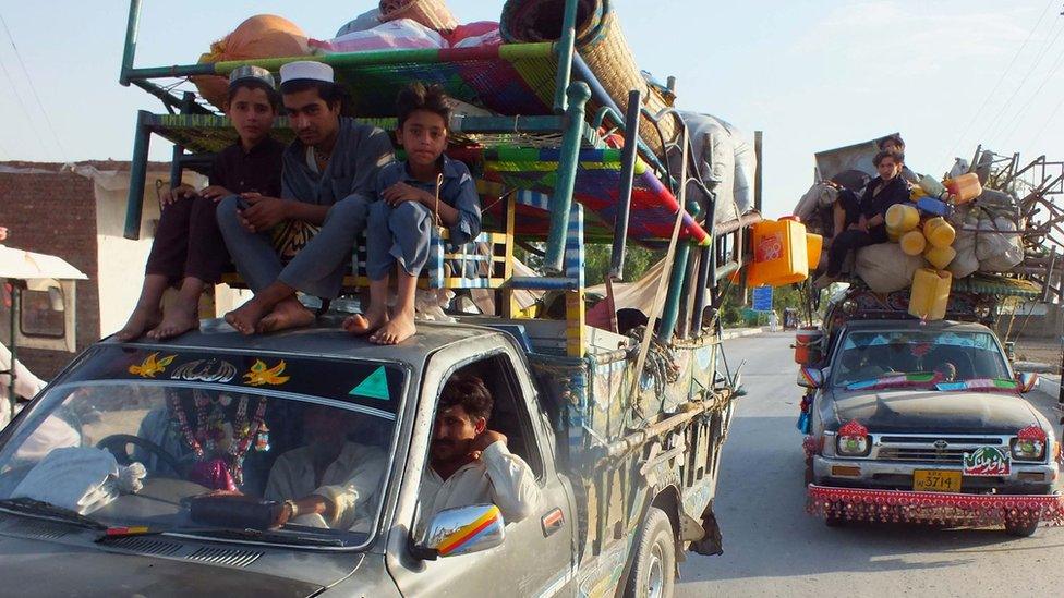 Internally displaced Pakistanis, fleeing from military operations against Taliban militants in North Waziristan, arrive in Bannu, a town on the edge of Pakistan's lawless tribal belt of Waziristan, on June 11, 2014.