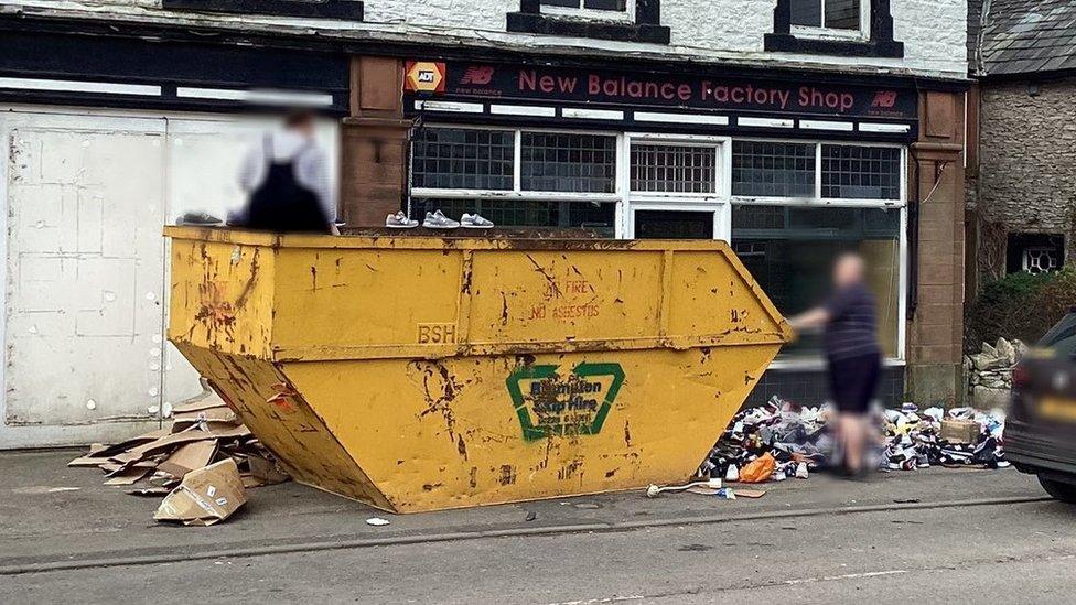 Skip and trainers outside New Balance store, Shap