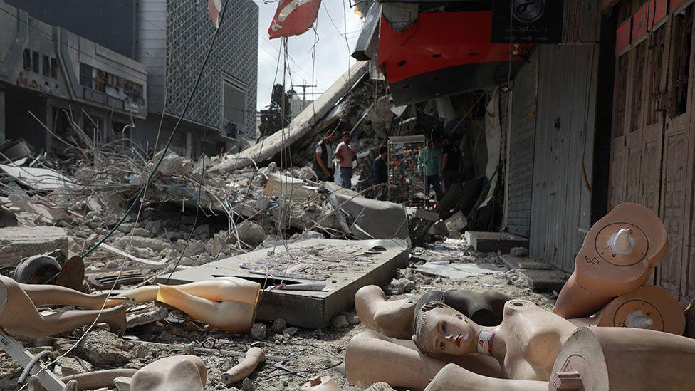 Broken mannequins lie on the floor outside a shop damaged by an Israeli air strike in Gaza City