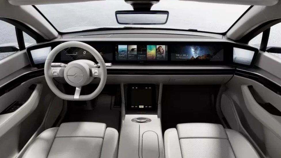 A panoramic dashboard visible inside the concept car