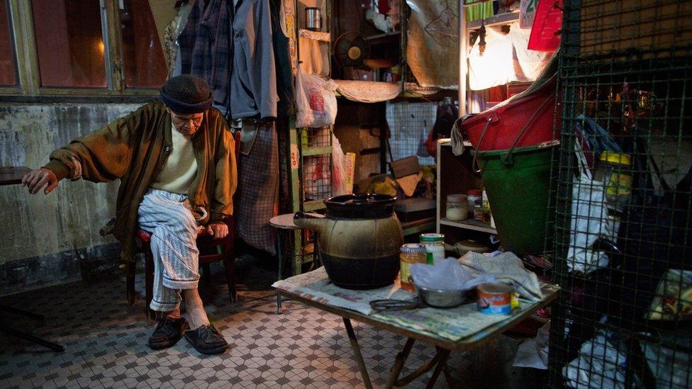 An old man in a cage apartment in Hong Kong in 2010