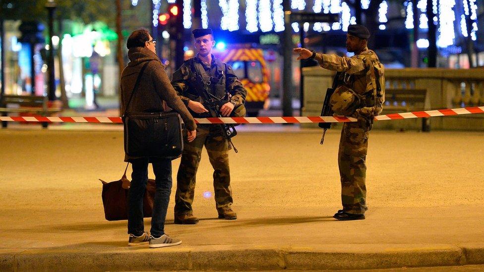 Police officers secure the area after a gunman opened fire on Champs Elysees in Paris, 20 April 2017