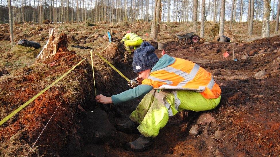 Archaeologist Leanne Demay recording the walls of the structure