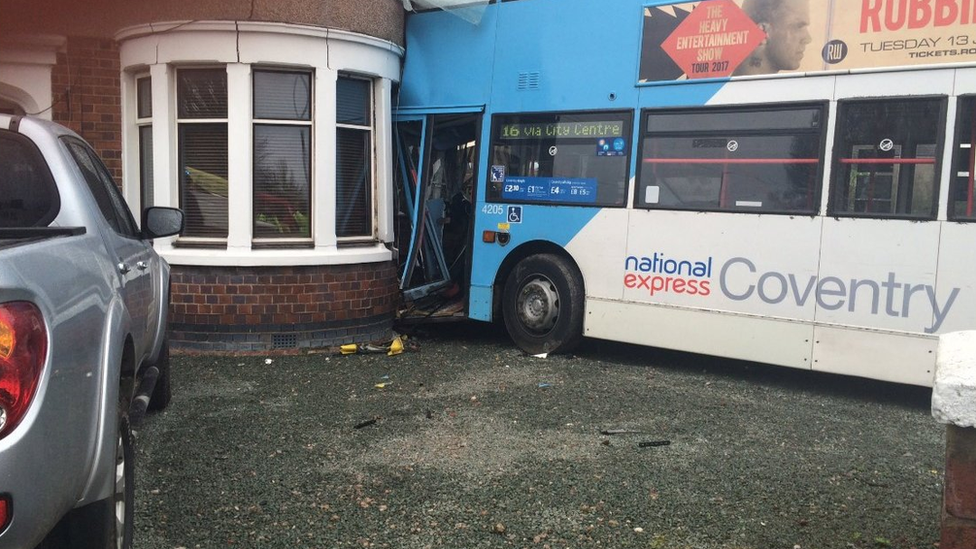 Bus crashes into side of house