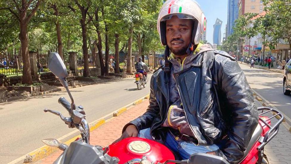 Moses Lugalia on his electric motorbike in Nairobi, Kenya