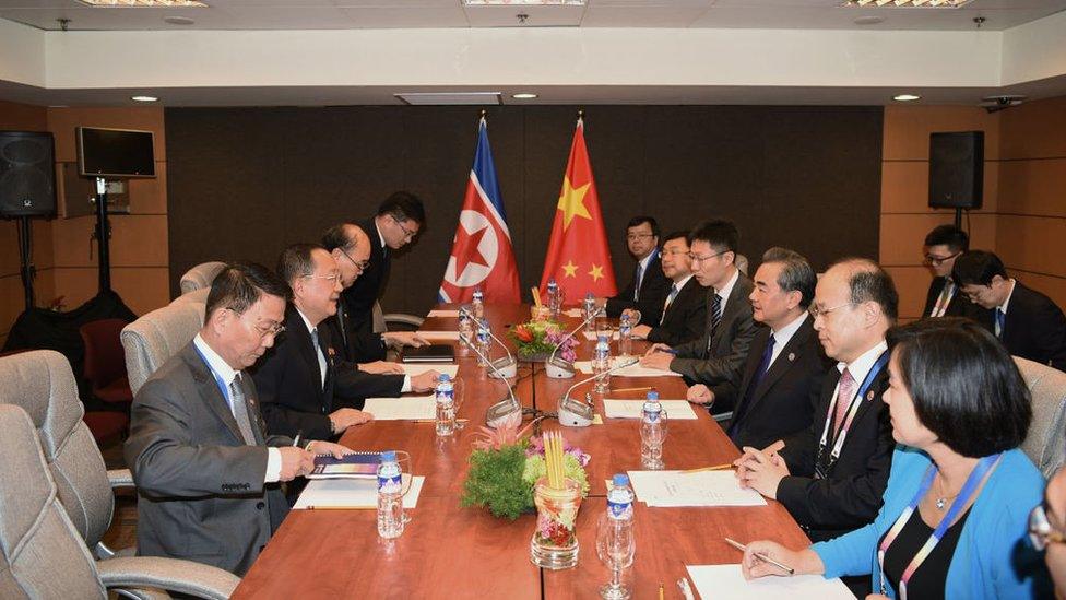 China's Foreign Minister Wang Yi (3rd R) speaks with North Korea's Foreign Minister Ri Yong Ho (2nd L) during their bilateral meeting on the sidelines of the Association of Southeast Asian Nations (ASEAN) regional security forum in Manila