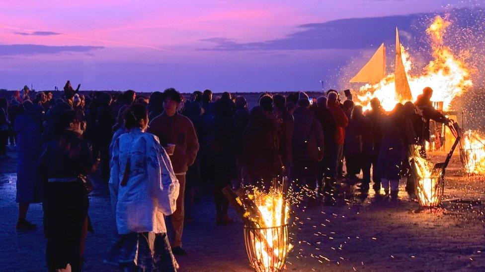 People gather on the beach to remember the tragedy