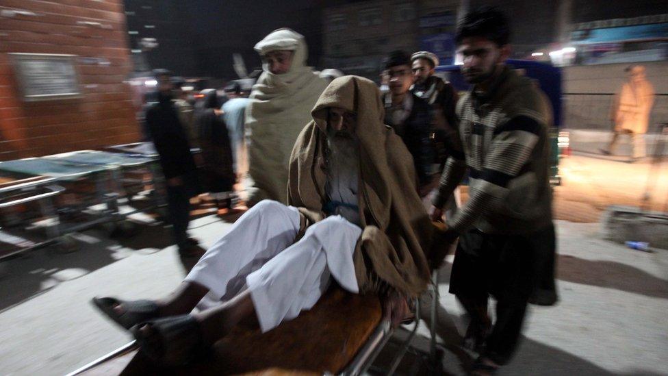 A man being rushed to hospital in Peshawar after the quake