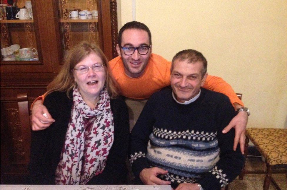 Emma Loosely, Father Jacques and a friend seated at a table