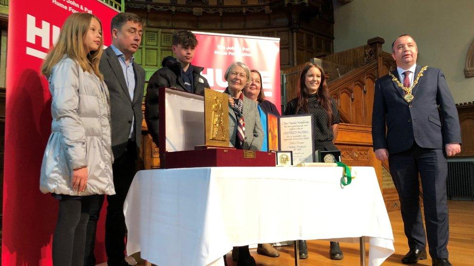 Hume family presenting award with Derry and Strabane Mayor Brian Tierney