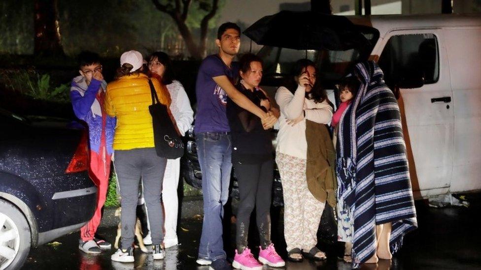 People react during a quake in Mexico City