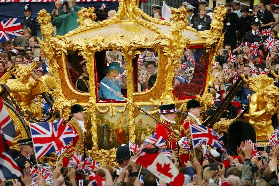 Queen Elizabeth (R) and Prince Philip ride in the Golden State Carriage at the head of a parade from Buckingham Palace to St Paul's Cathedral celebrating the Queen's Golden Jubilee June 4, 2002