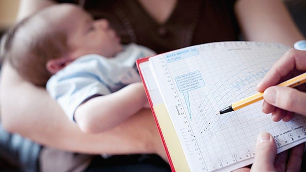 Checking a baby's personal child health record or red book