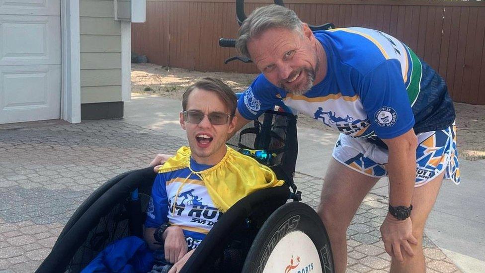 Riley and his father Jim play Disney music through a speaker as they run