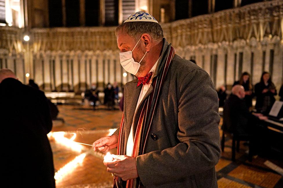 A Jewish man helps light six hundred candles in the shape of the Star of David, in the Chapter House at York Minster in York, part of York Minster's commemoration for International Holocaust Day