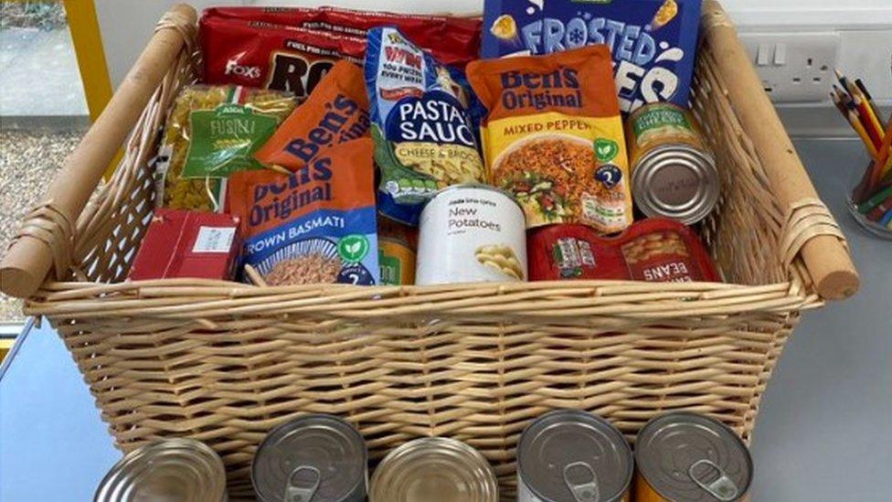 Basket of tinned and packaged food on a table within the staff area of Milton Keynes Hospital