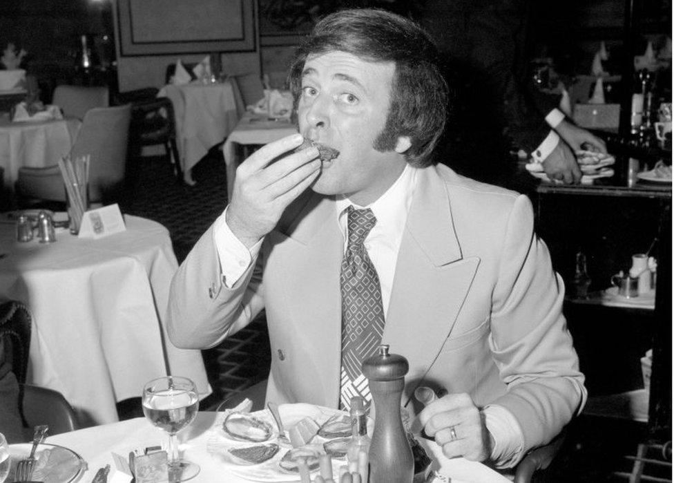 Sir Terry Wogan sampling an oyster at a reception to celebrate the opening of the oyster season at Scott's restaurant in London in 1973