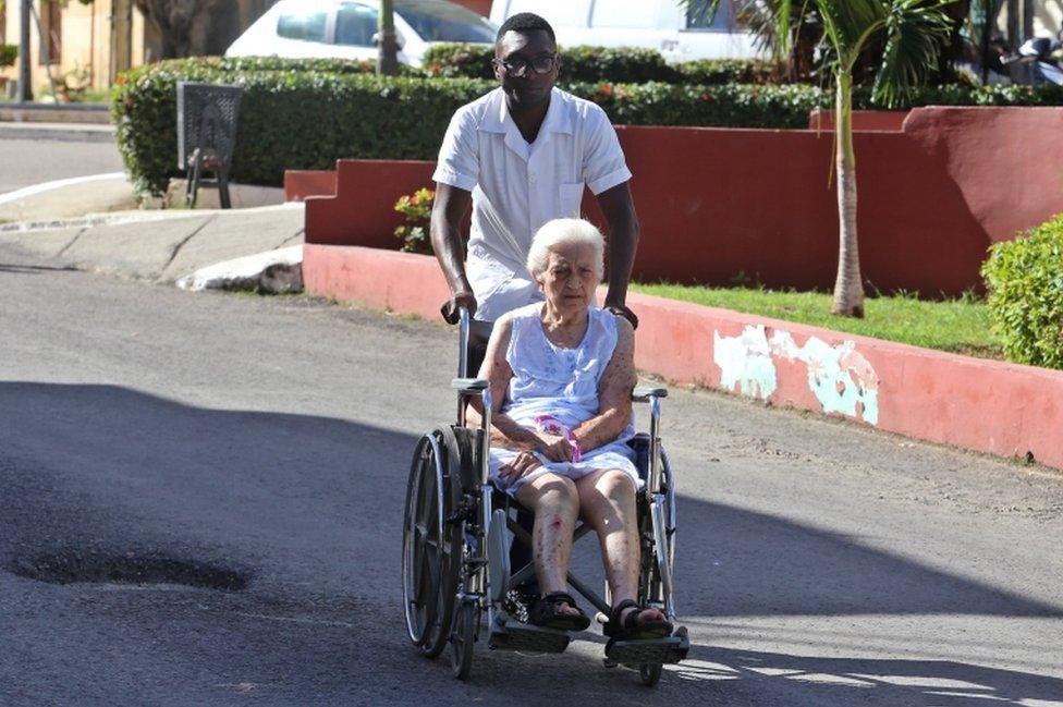 A health worker helps a lady in a wheelchair at the Calixto Garcia hospital in Havana, Cuba, on 14 November 2018