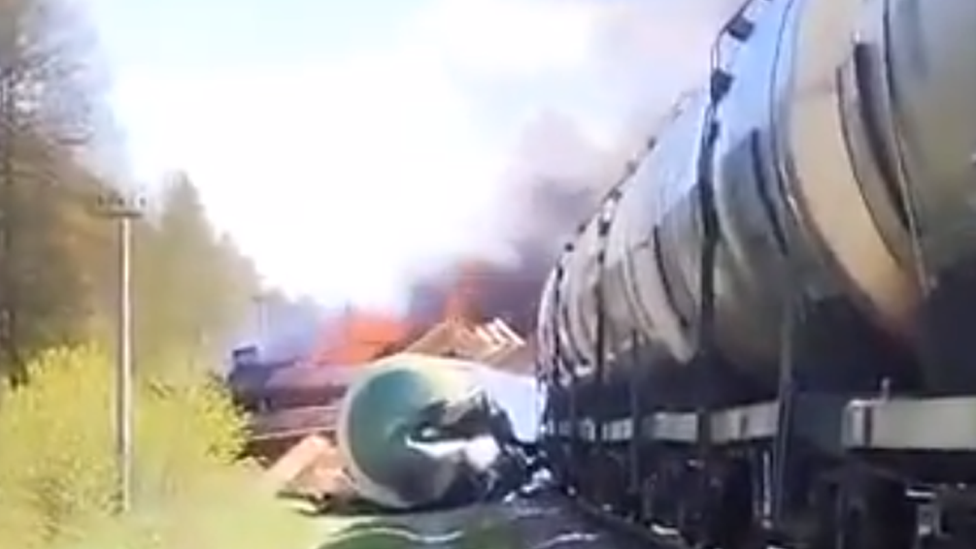 Locomotive on fire and train carriage turned over