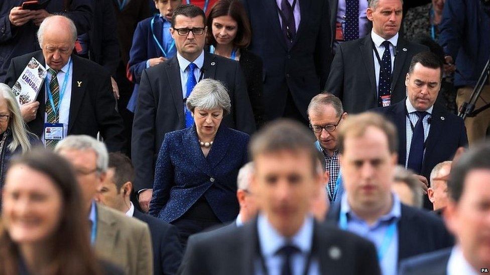 Theresa May leaves the conference centre in Manchester