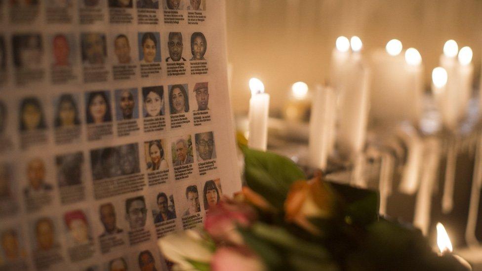 The photographs of the Westgate Shopping Centre victims are placed next to burning candles outside the Westgate Shopping Centre on September 28, 2013 in Nairobi, Kenya