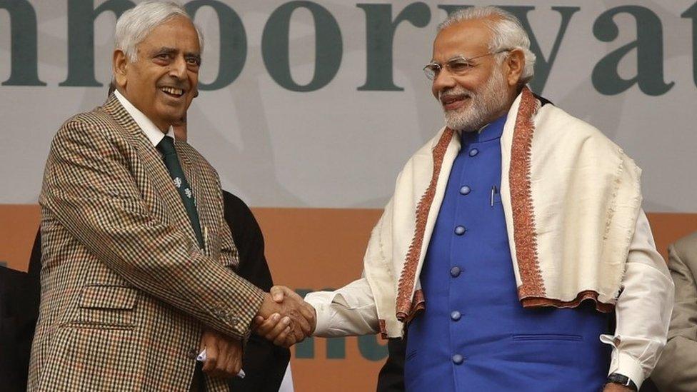 Indian Prime Minister Narendra Modi, right, shakes hands with Chief Minister of Jammu and Kashmir state Mufti Mohammad Sayeed during a public rally in Srinagar, Indian controlled Kashmir, Saturday, Nov. 7, 2015.