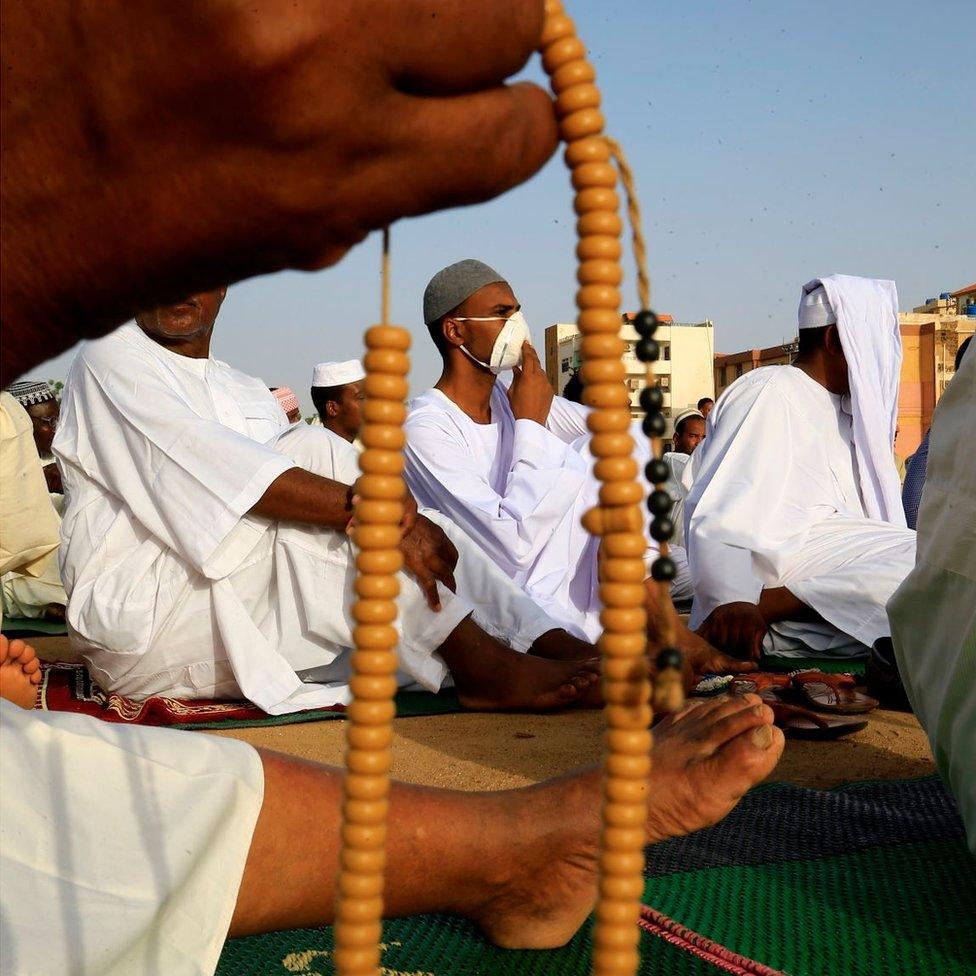 Man in facemask praying in Khartoum