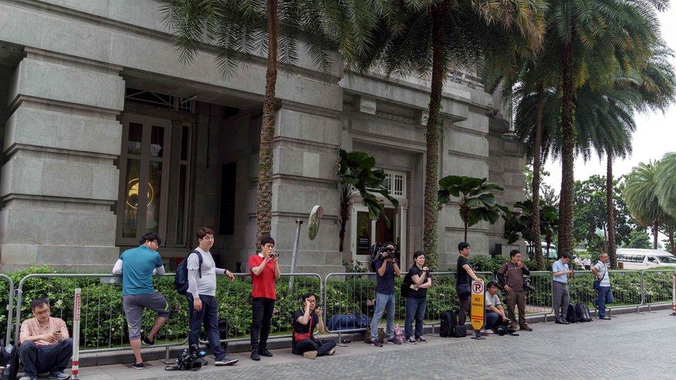 Reporters outside Kim's hotel