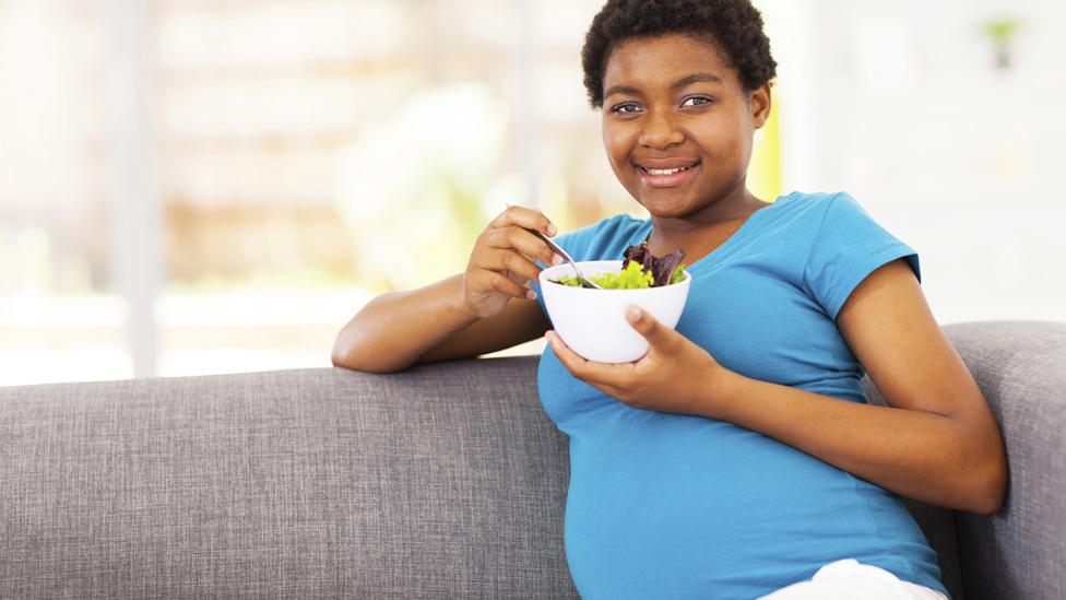 Pregnant woman sitting down